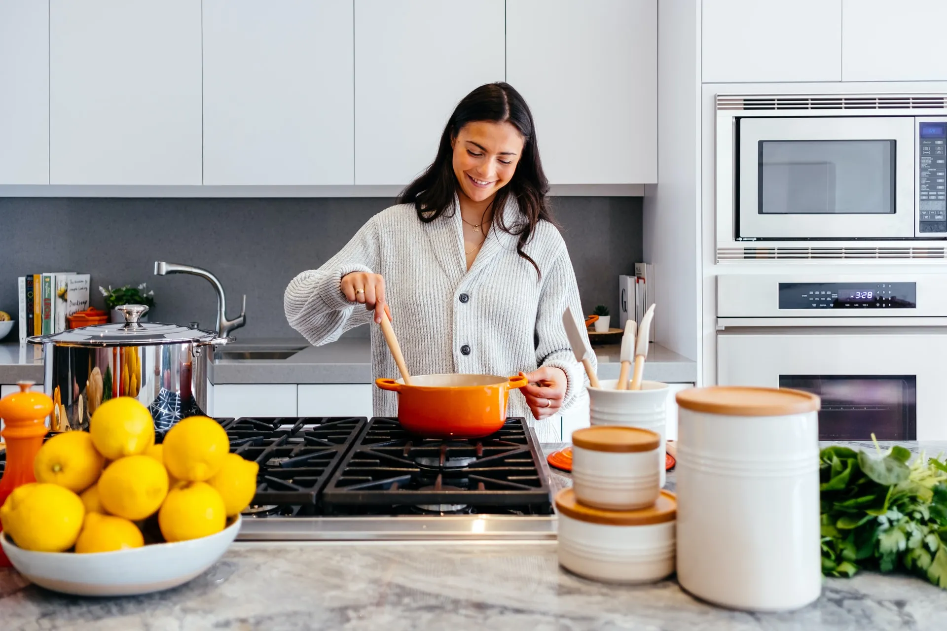 Woman cooks dinner on the stove.