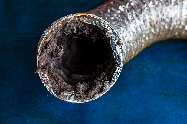 View of a clogged duct filled with lint, underscoring the importance of regular duct cleaning