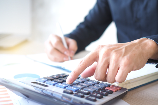 View of a person calculating HVAC maintenance costs, highlighting the financial benefits of regular service plans.