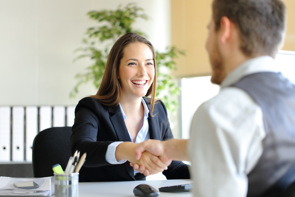 View of a professional shaking hands with a client, emphasizing trust and professionalism of top insulation installers.