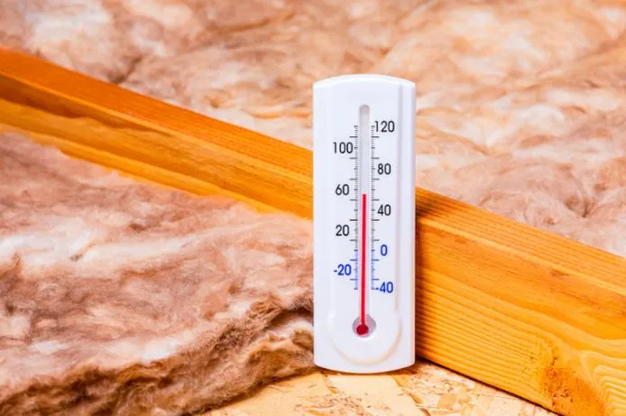 View of a room thermometer showing the temperature of an attic after professional attic insulation.