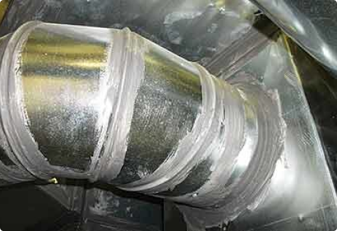 Close-up of a sealed HVAC duct joint with mastic applied — illustrating what a duct seal is and how technicians skillfully use it to prevent air leaks and improve energy efficiency.