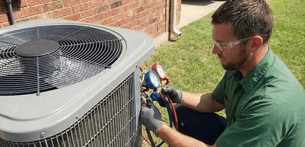 HVAC technician inspecting an outdoor air conditioning unit to estimate the cost of a new HVAC system for a residential home.